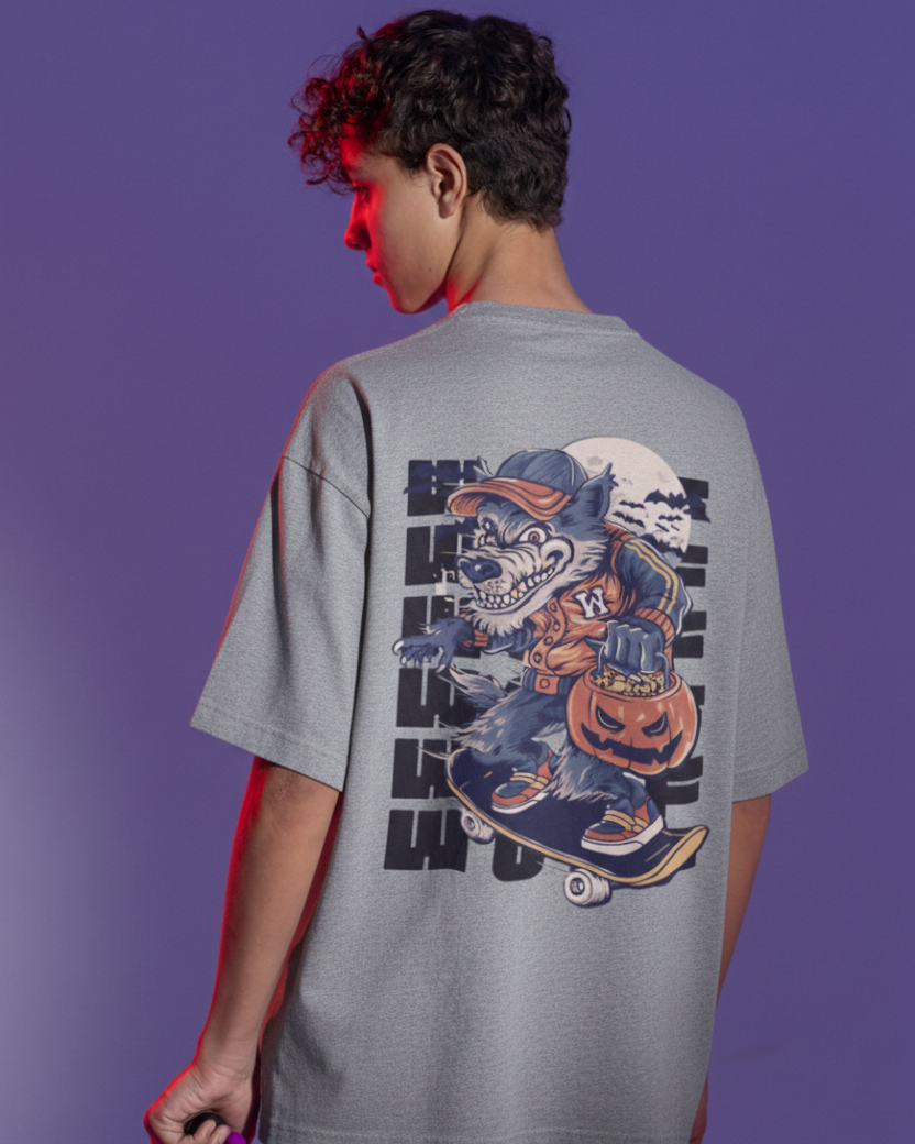 Person wearing a gray t-shirt with a graphic design on the back against a purple background