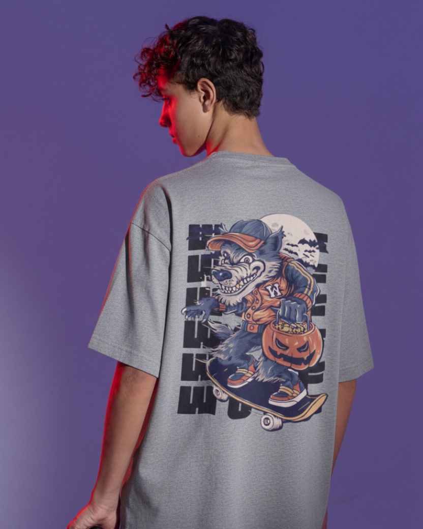 Person wearing a gray t-shirt with a graphic design on the back against a purple background