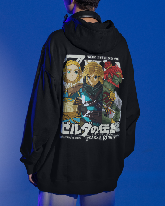 Person wearing a black hoodie with an anime-themed design on the back against a blue background