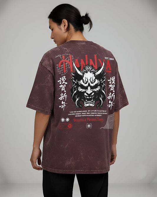 Person wearing a maroon t-shirt with a dragon design and text on the back, on a plain background
